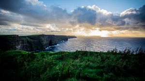 Preview wallpaper coast, rocks, sea, grass, nature