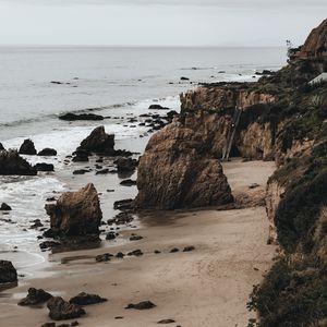 Preview wallpaper coast, rocks, stones, sand, sea