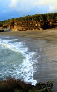 Preview wallpaper coast, sand, sea, waves, foam, rocks