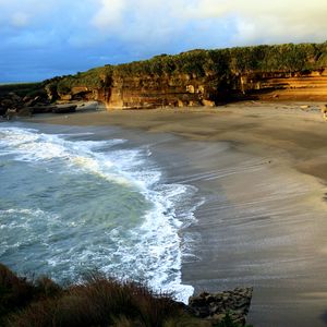 Preview wallpaper coast, sand, sea, waves, foam, rocks