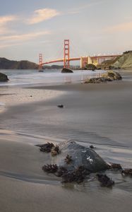 Preview wallpaper coast, sand, stones, sea, bridge
