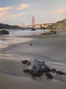 Preview wallpaper coast, sand, stones, sea, bridge