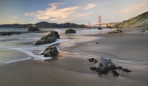 Preview wallpaper coast, sand, stones, sea, bridge