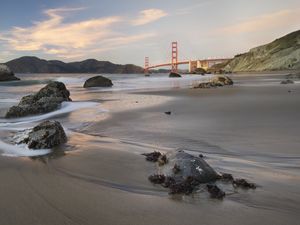 Preview wallpaper coast, sand, stones, sea, bridge