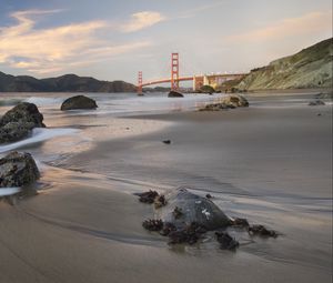 Preview wallpaper coast, sand, stones, sea, bridge