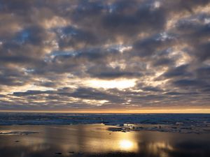 Preview wallpaper coast, sand, water, clouds, sun, twilight, reflection