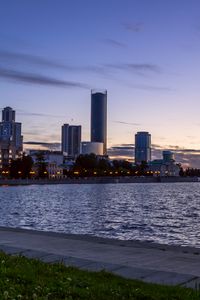 Preview wallpaper coast, sea, buildings, lights, twilight, city