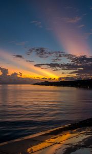 Preview wallpaper coast, sea, clouds, rays, sunset, dark
