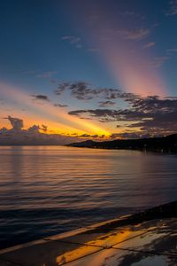 Preview wallpaper coast, sea, clouds, rays, sunset, dark
