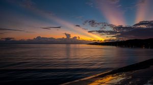 Preview wallpaper coast, sea, clouds, rays, sunset, dark