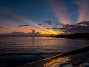 Preview wallpaper coast, sea, clouds, rays, sunset, dark