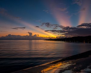 Preview wallpaper coast, sea, clouds, rays, sunset, dark