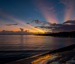 Preview wallpaper coast, sea, clouds, rays, sunset, dark