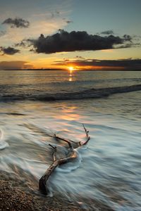 Preview wallpaper coast, sea, clouds, sun, sunset