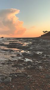Preview wallpaper coast, sea, pebbles, stones, sunset