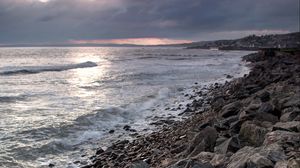 Preview wallpaper coast, sea, pebbles, stones, clouds, nature