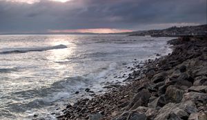 Preview wallpaper coast, sea, pebbles, stones, clouds, nature