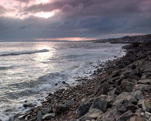 Preview wallpaper coast, sea, pebbles, stones, clouds, nature