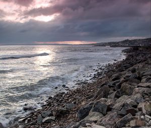 Preview wallpaper coast, sea, pebbles, stones, clouds, nature