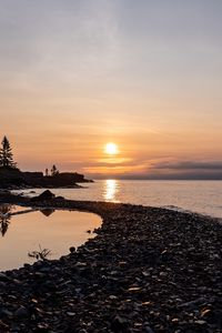 Preview wallpaper coast, sea, pebbles, nature, sunrise