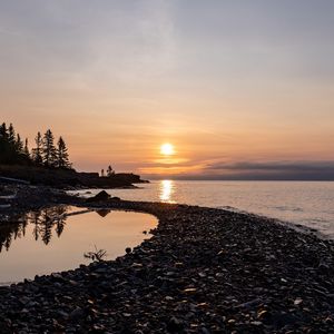 Preview wallpaper coast, sea, pebbles, nature, sunrise