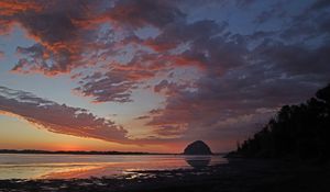 Preview wallpaper coast, sea, rock, hill, evening