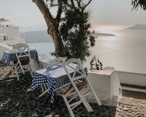 Preview wallpaper coast, sea, table, chairs, aesthetics