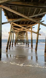 Preview wallpaper coast, sea, waves, logs, pier