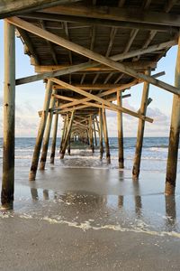 Preview wallpaper coast, sea, waves, logs, pier