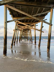 Preview wallpaper coast, sea, waves, logs, pier