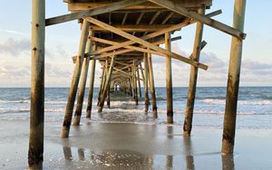 Preview wallpaper coast, sea, waves, logs, pier