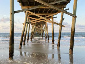 Preview wallpaper coast, sea, waves, logs, pier