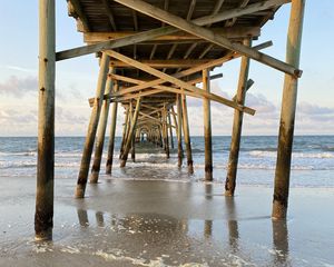 Preview wallpaper coast, sea, waves, logs, pier