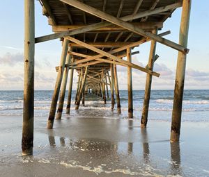 Preview wallpaper coast, sea, waves, logs, pier