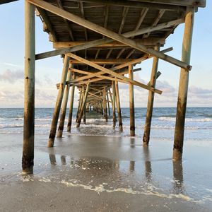 Preview wallpaper coast, sea, waves, logs, pier