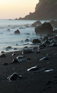 Preview wallpaper coast, stones, rock, sea, landscape, twilight