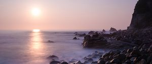 Preview wallpaper coast, stones, rocks, sun, water, fog, landscape