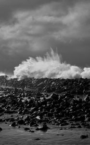 Preview wallpaper coast, stones, sea, splashes, waves, black and white, storm