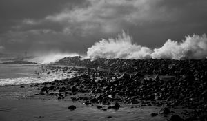 Preview wallpaper coast, stones, sea, splashes, waves, black and white, storm