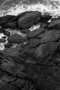 Preview wallpaper coast, stones, sea, waves, black and white, aerial view