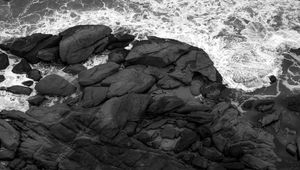 Preview wallpaper coast, stones, sea, waves, black and white, aerial view