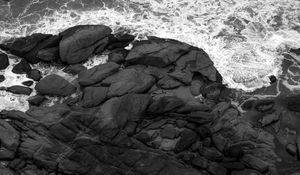 Preview wallpaper coast, stones, sea, waves, black and white, aerial view