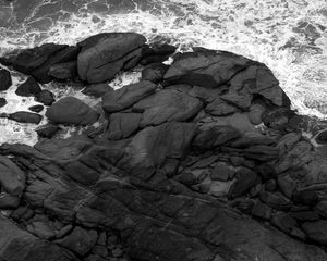 Preview wallpaper coast, stones, sea, waves, black and white, aerial view