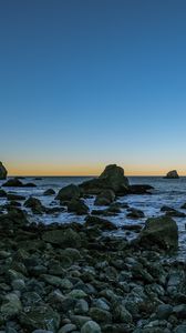 Preview wallpaper coast, stones, sea, water, landscape, twilight