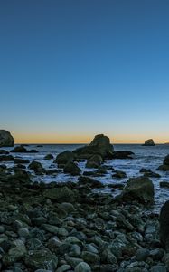 Preview wallpaper coast, stones, sea, water, landscape, twilight