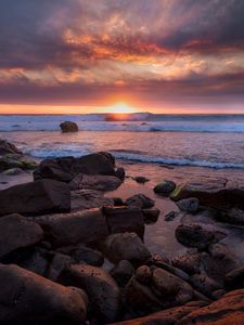 Preview wallpaper coast, stones, sea, sun, sunset