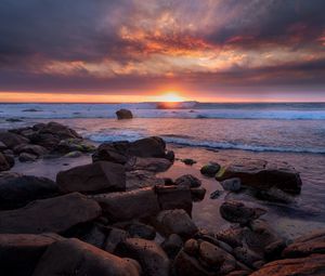 Preview wallpaper coast, stones, sea, sun, sunset