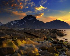 Preview wallpaper coast, stones, smooth, wet, sea, mountains, evening, sky