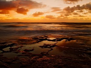 Preview wallpaper coast, stony, sea, pools, water, decline, evening, sky, landscape, waves