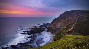 Preview wallpaper coast, sunset, rocks, surf